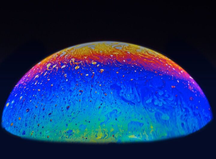 A colorful abstract sphere resembling a planet with swirling cosmic patterns and vibrant hues.