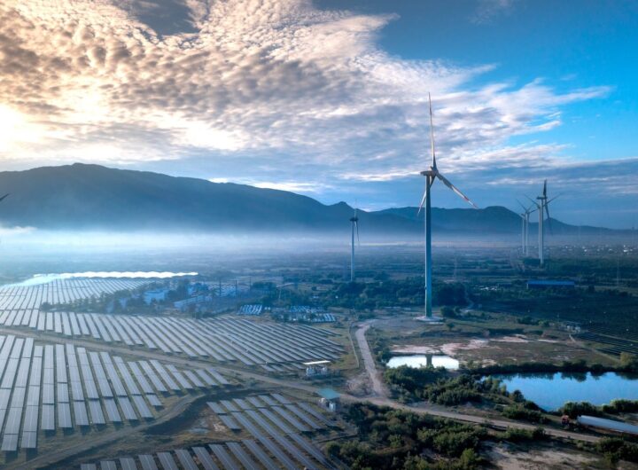Stunning aerial view of wind turbines and solar panels in a landscape, showcasing renewable energy technologies.