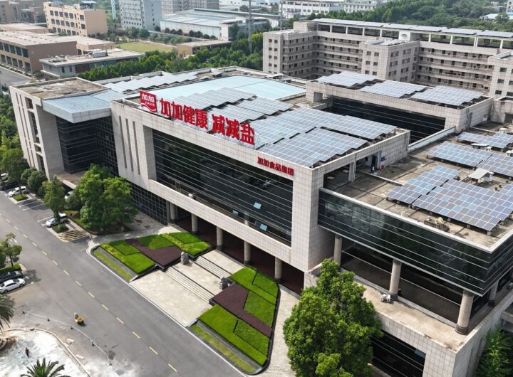Aerial view of a modern building with solar panels, showcasing sustainable architecture.