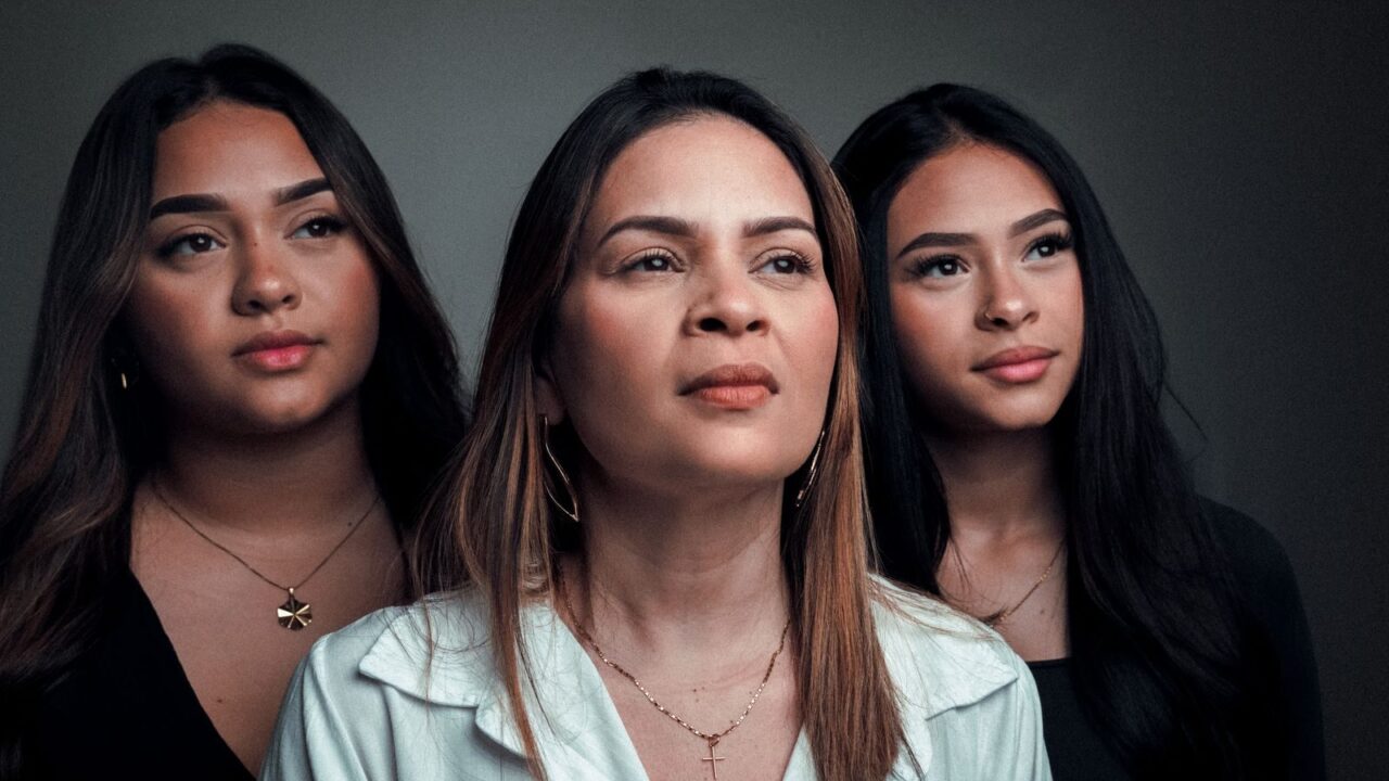 Portrait of three women looking forward with a confident and poised expression.
