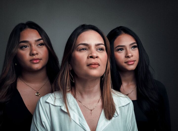 Portrait of three women looking forward with a confident and poised expression.