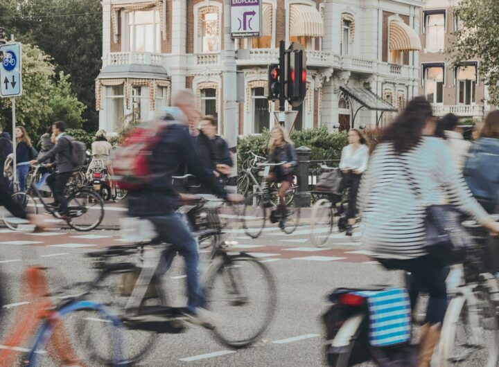 people riding bicycle on road during daytime