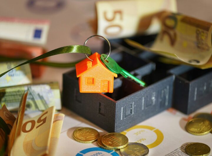 A small house on top of a pile of money