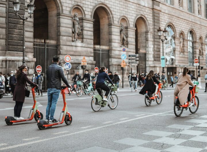 people riding bicycles on road during daytime