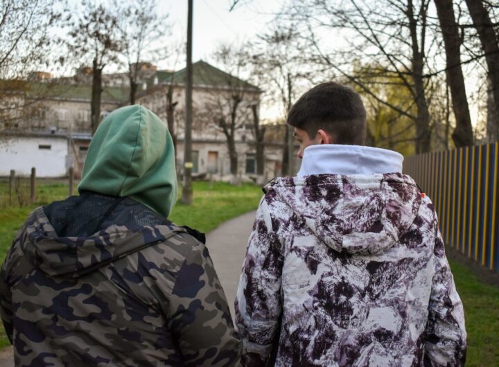 a couple of people that are standing in the grass