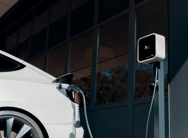 a white car plugged in to a charging station