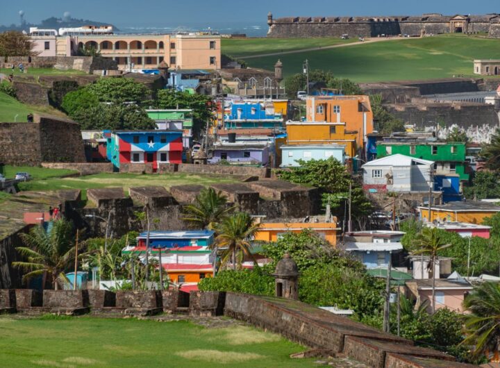 A vibrant view of the colorful La Perla neighborhood against historic San Juan fortifications.