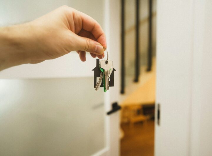 A hand holding a key to a door